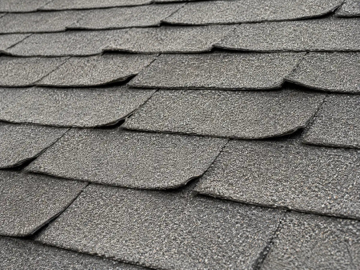 Worn, curling shingles seen up close